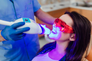 Teeth whitening for woman. Bleaching of the teeth at dentist clinic.