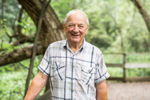 A happy cheerful Senior man in the forest park