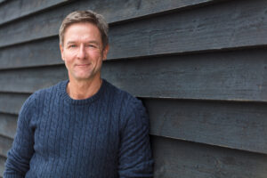 Man smiling in blue sweater