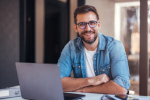 Smiling man at laptop