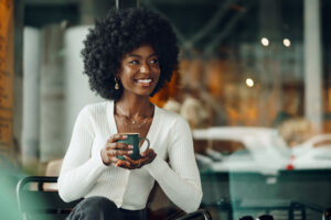 Woman holding coffee mug smiling