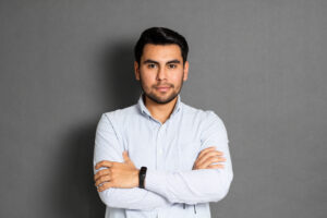 Confident young man with arms crossed